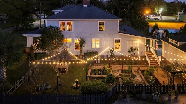 view of back house at twilight