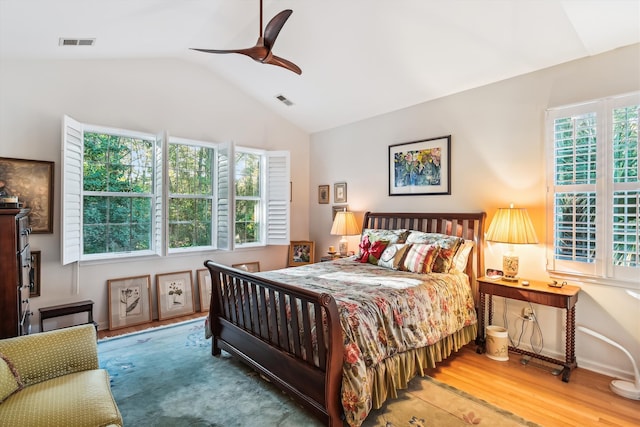 bedroom featuring hardwood / wood-style floors, ceiling fan, and lofted ceiling