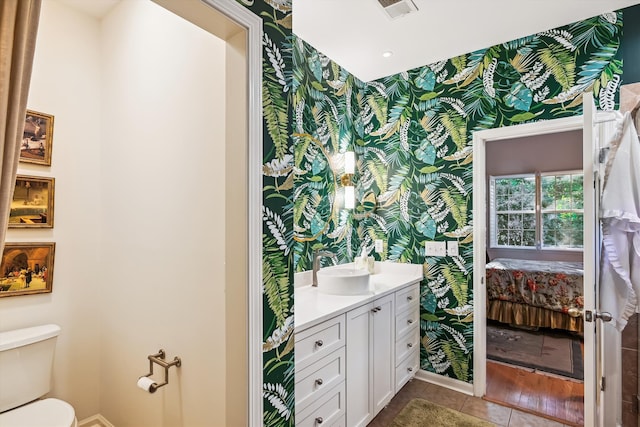 bathroom with tile patterned floors, vanity, and toilet