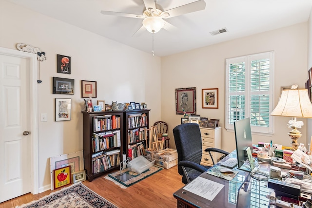 office space with wood-type flooring and ceiling fan