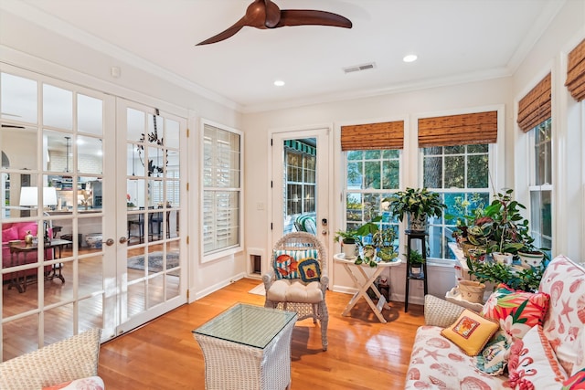 sunroom / solarium with ceiling fan and french doors