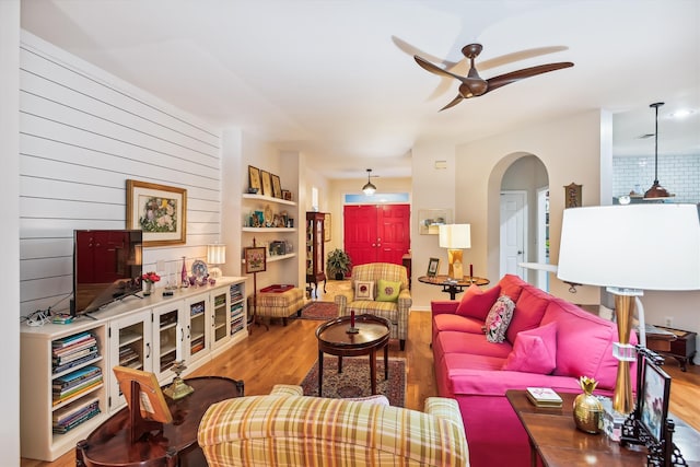 living room with ceiling fan and wood-type flooring