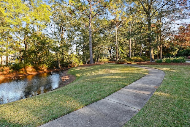 exterior space with a water view and a yard