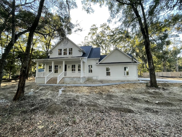 back of property with a porch