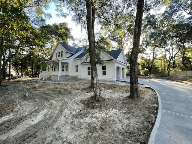 view of front of home with a garage and a porch