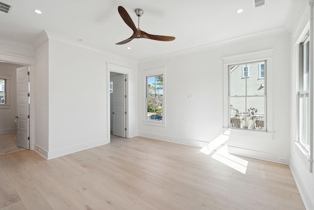 spare room with ornamental molding, ceiling fan, and light wood-type flooring