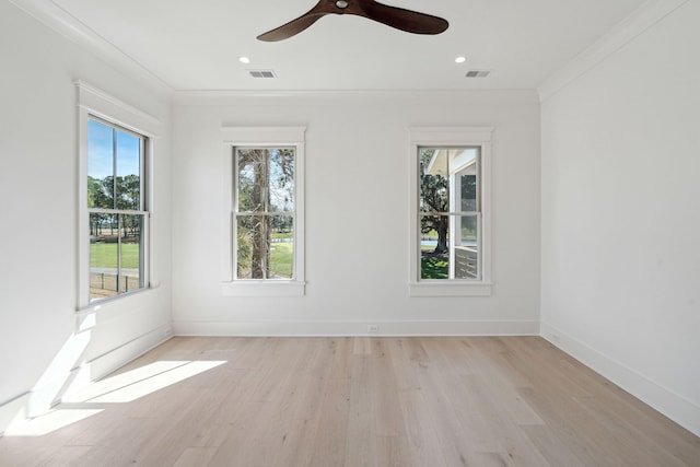 empty room featuring ornamental molding, ceiling fan, and light wood-type flooring