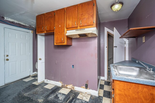 113 America St Unit A, B, C, D, Charleston, SC 29403 - kitchen with dark flooring, a sink, under cabinet range hood, brown cabinets, and baseboards