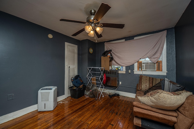 sitting room featuring cooling unit, hardwood / wood-style floors, and ceiling fan