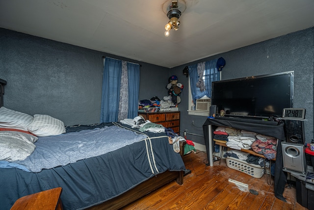 bedroom featuring cooling unit and hardwood / wood-style floors