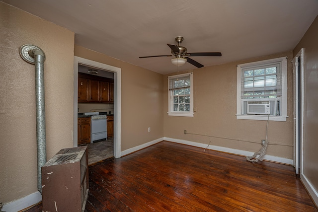 unfurnished bedroom with ceiling fan, cooling unit, and dark hardwood / wood-style floors