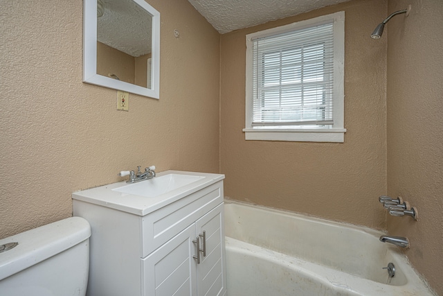 full bathroom with tub / shower combination, a textured ceiling, vanity, and toilet