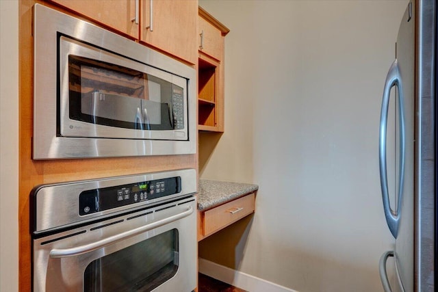 kitchen featuring light brown cabinetry and stainless steel appliances