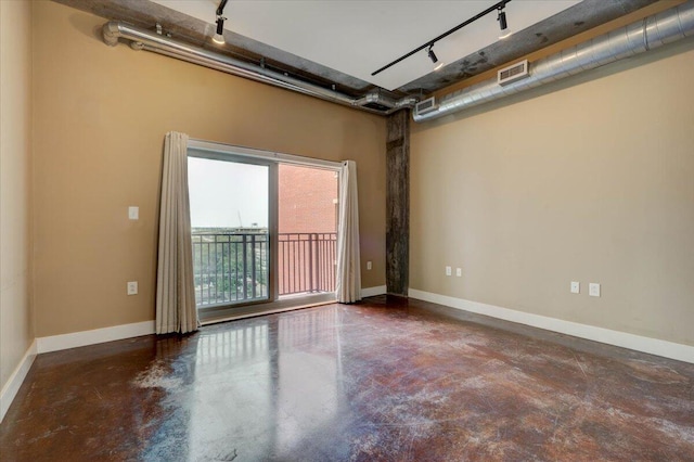 unfurnished room with track lighting