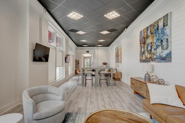 dining room featuring a paneled ceiling and light hardwood / wood-style flooring