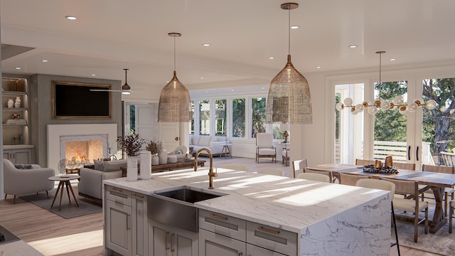 3307 Waterway Blvd, Isle Of Palms, SC 29451 - kitchen featuring open floor plan, a sink, light wood-type flooring, light stone countertops, and recessed lighting
