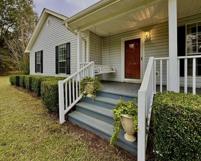 view of exterior entry with a porch