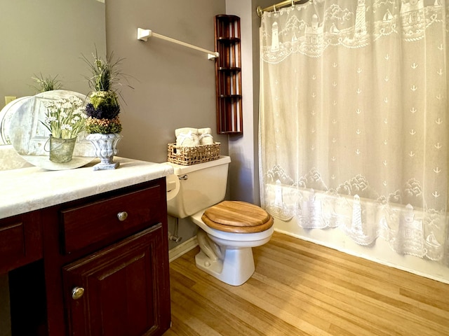 bathroom with hardwood / wood-style floors and toilet