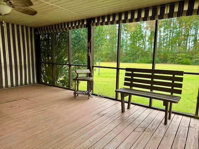 unfurnished sunroom with ceiling fan