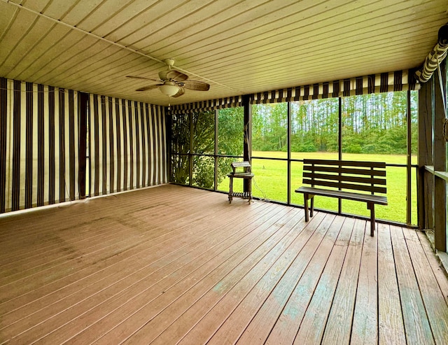 unfurnished sunroom featuring ceiling fan