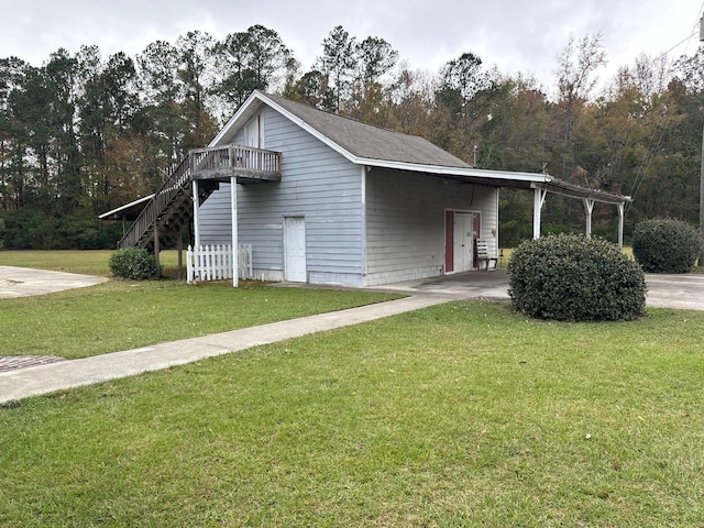 view of side of home with a carport and a lawn