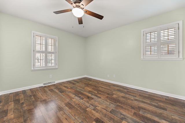 spare room featuring ceiling fan and dark hardwood / wood-style floors