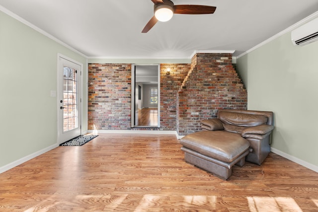 unfurnished room with brick wall, a wall unit AC, ornamental molding, ceiling fan, and light wood-type flooring