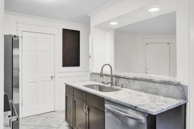2159 Spoleto Ln Unit E, North Charleston, SC 29406 - kitchen featuring appliances with stainless steel finishes, a sink, dark brown cabinets, crown molding, and light stone countertops