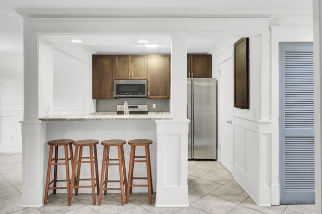 2159 Spoleto Ln Unit E, North Charleston, SC 29406 - kitchen with stainless steel appliances, a kitchen breakfast bar, recessed lighting, and dark brown cabinetry