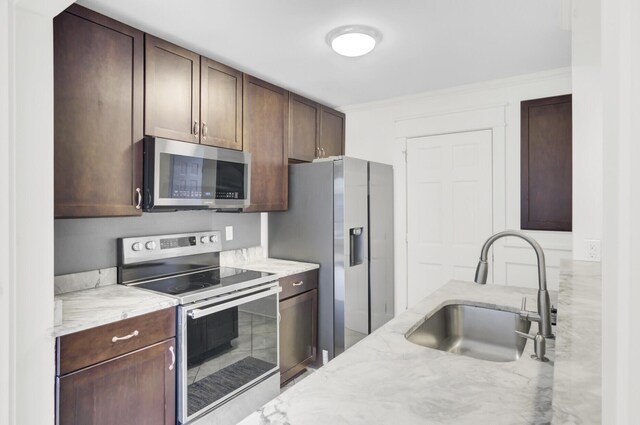 2159 Spoleto Ln Unit E, North Charleston, SC 29406 - kitchen featuring appliances with stainless steel finishes, a sink, light stone counters, and dark brown cabinets