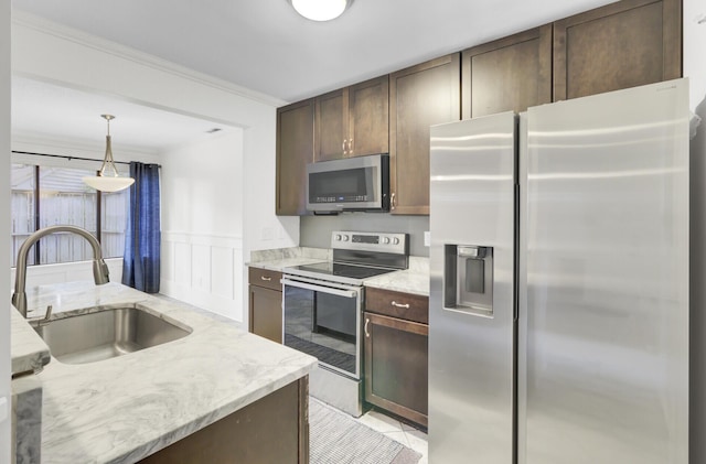 2159 Spoleto Ln Unit E, North Charleston, SC 29406 - kitchen featuring stainless steel appliances, a sink, dark brown cabinetry, light stone counters, and crown molding
