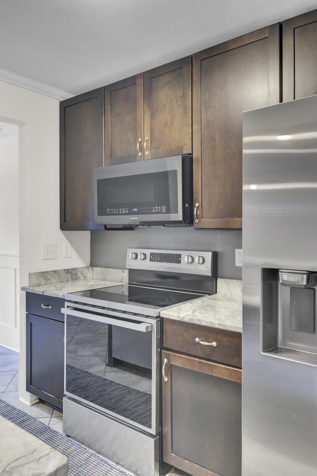2159 Spoleto Ln Unit E, North Charleston, SC 29406 - kitchen with stainless steel appliances, dark brown cabinets, crown molding, and light tile patterned floors
