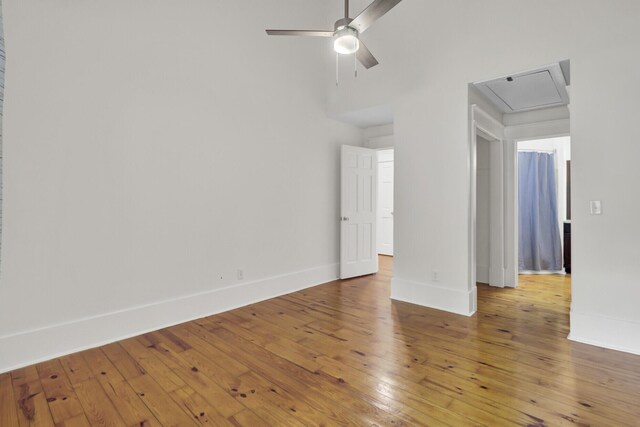2159 Spoleto Ln Unit E, North Charleston, SC 29406 - spare room featuring baseboards, ceiling fan, light wood-type flooring, and a high ceiling