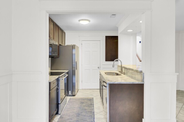 2159 Spoleto Ln Unit E, North Charleston, SC 29406 - kitchen featuring a sink, range with electric cooktop, ornamental molding, light tile patterned flooring, and dark brown cabinetry