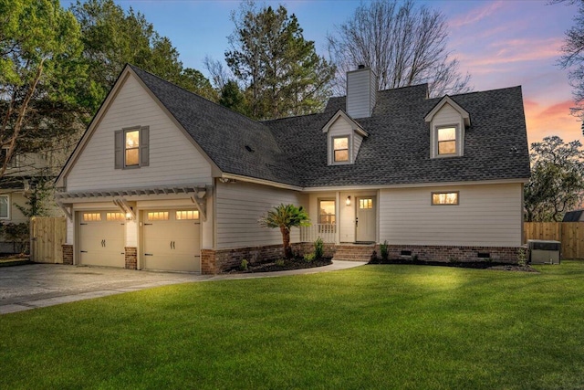 view of front of house with a front lawn, fence, concrete driveway, an attached garage, and a chimney