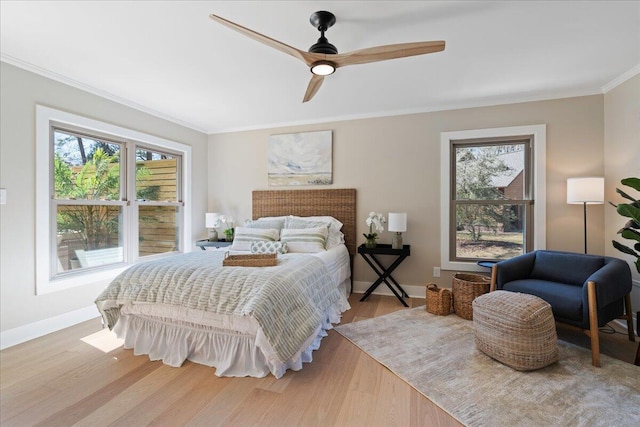 bedroom featuring ceiling fan, wood finished floors, baseboards, and ornamental molding