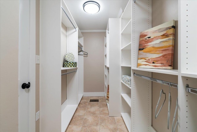 walk in closet featuring light tile patterned floors and visible vents