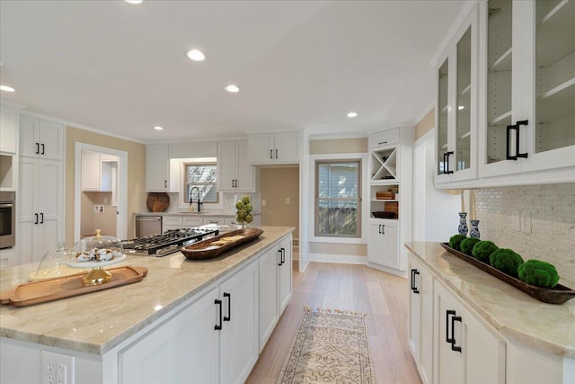 kitchen featuring white cabinetry, light wood-style flooring, appliances with stainless steel finishes, and a sink