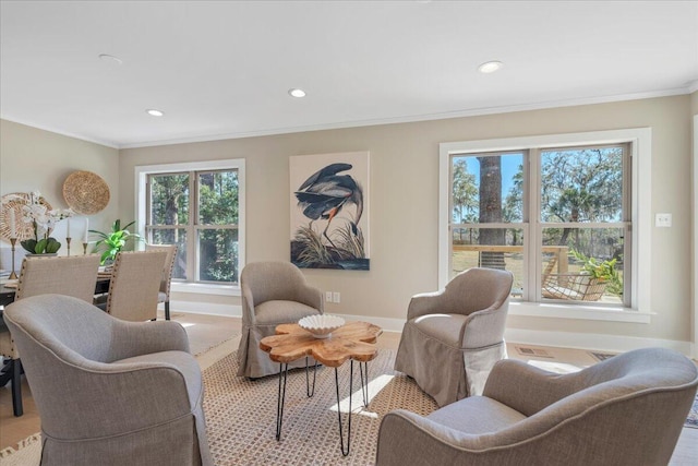 living area featuring recessed lighting, crown molding, and baseboards