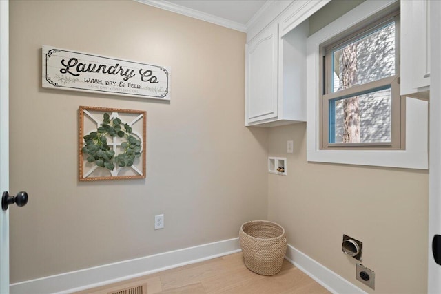 washroom featuring ornamental molding, wood finished floors, cabinet space, baseboards, and hookup for an electric dryer