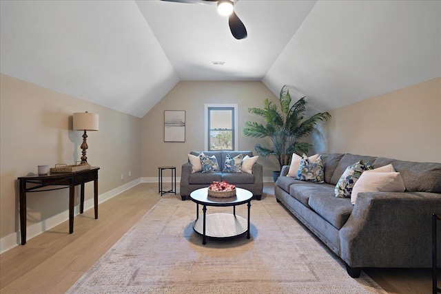 living room with a ceiling fan, visible vents, baseboards, lofted ceiling, and light wood-type flooring