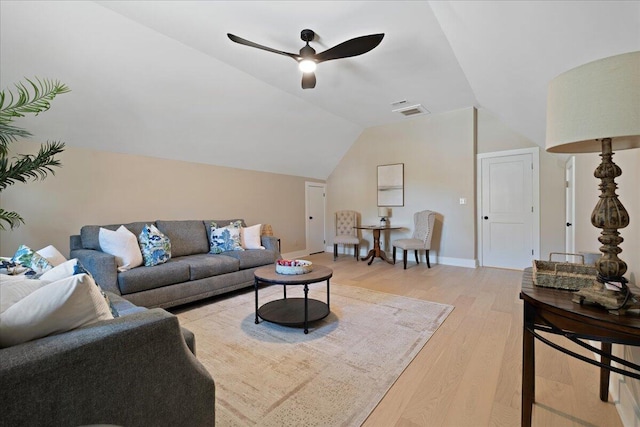 living area featuring visible vents, baseboards, light wood-type flooring, vaulted ceiling, and a ceiling fan