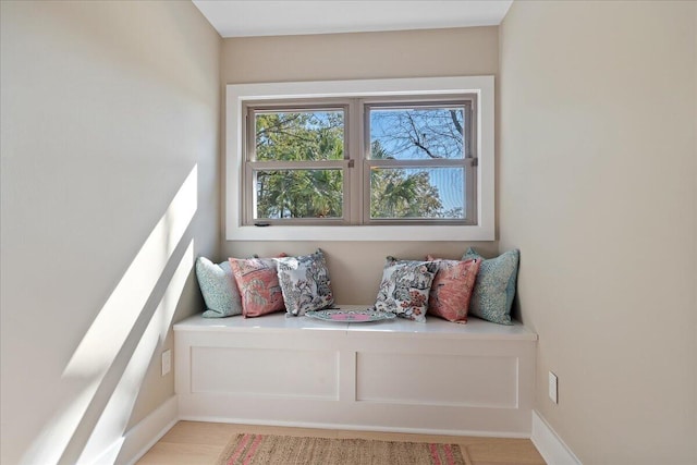 living area featuring baseboards