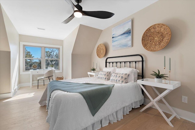 bedroom featuring visible vents, wood finished floors, baseboards, and ceiling fan