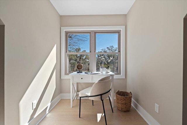 office area featuring baseboards and light wood-style flooring