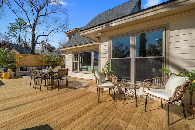 deck with outdoor lounge area and outdoor dining area