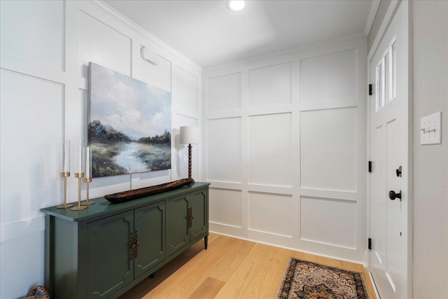 hallway featuring a decorative wall and light wood-style floors