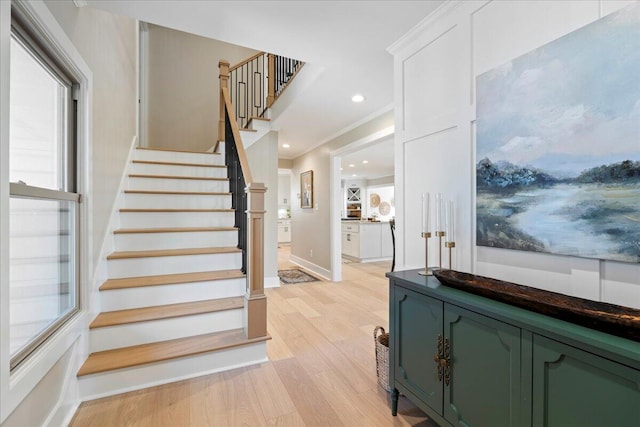 stairs featuring recessed lighting, baseboards, wood finished floors, and ornamental molding