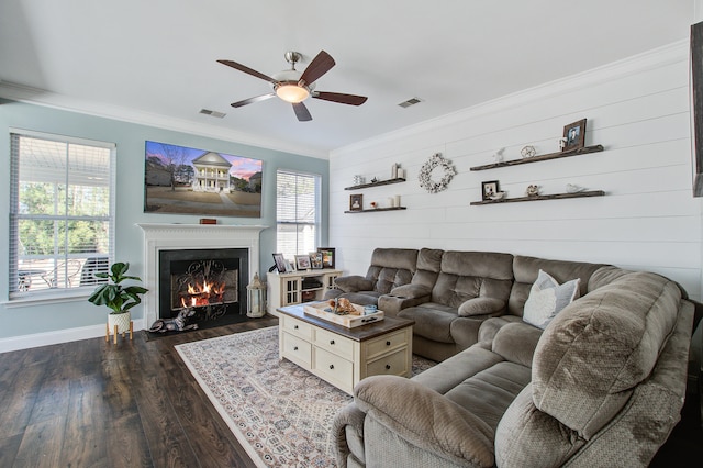 living room with visible vents, ornamental molding, and a wealth of natural light