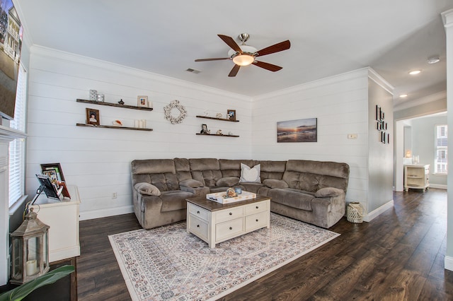 living area with ornamental molding, dark wood-style flooring, visible vents, and baseboards